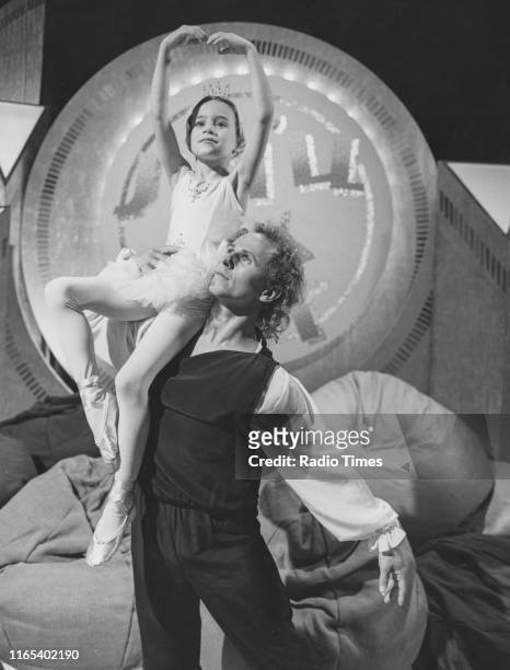 Dancer Wayne Sleep lifting a young fan in the air on the BBC television series 'Jim'll Fix It', 1984.