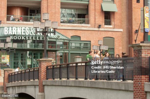 Johns Hopkins University students, walking over a bridge near a Barnes and Noble in the converted Pratt Street Power Plant complex, Inner Harbor...