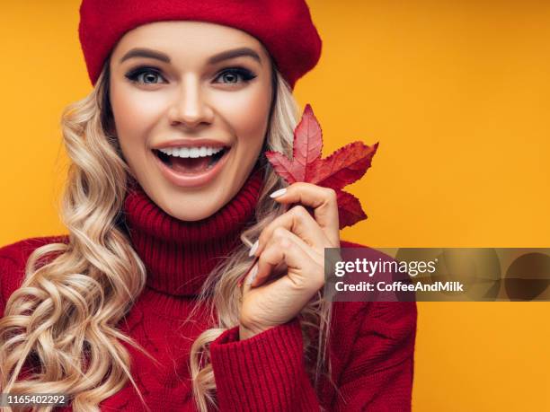 beautiful girl with autumn leaf - beautiful woman fall stock pictures, royalty-free photos & images