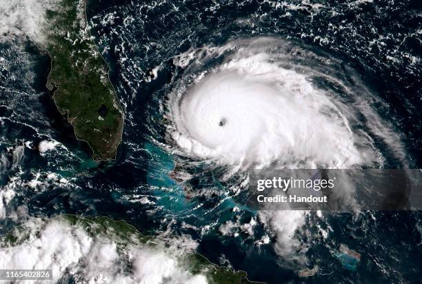 In this NOAA GOES-East satellite handout image, Hurricane Dorian, now a Cat. 5 storm, tracks towards the Florida coast taken at 13:20Z September 1,...