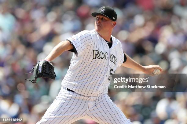 Pitcher Jake McGee of the Colorado Rockies throws in the seventh inning against the Los Angeles Dodgers at Coors Field on July 31, 2019 in Denver,...