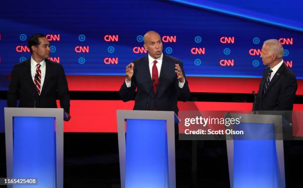 Democratic presidential candidate Sen. Cory Booker speaks while former Vice President Joe Biden and former housing secretary Julian Castro listen...