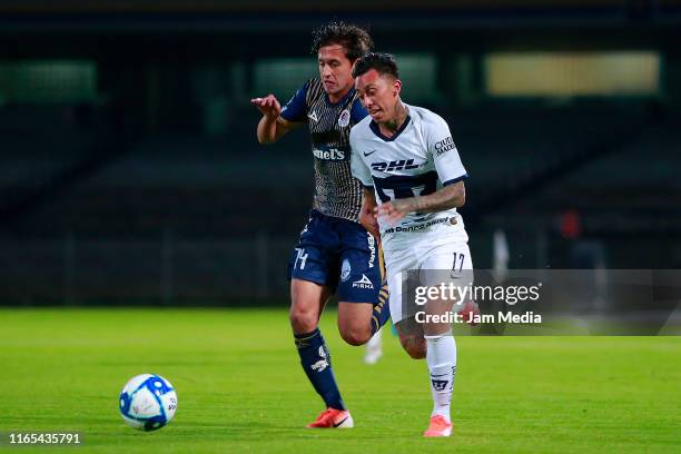 Carlos Gutierrez of San Luis fights for the ball with Martin Rodriguez of Pumas during the match between Pumas UNAM and Atletico San Luis as part of...