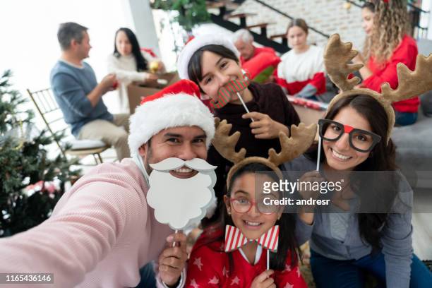 family taking a selfie on christmas day using props - prop stock pictures, royalty-free photos & images