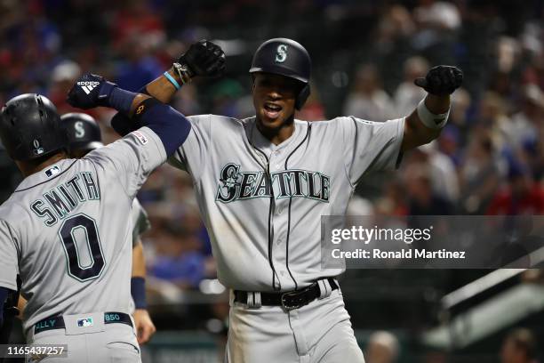 Keon Broxton of the Seattle Mariners celebrates a two-run homerun with Mallex Smith against the Texas Rangers in the eighth inning at Globe Life Park...