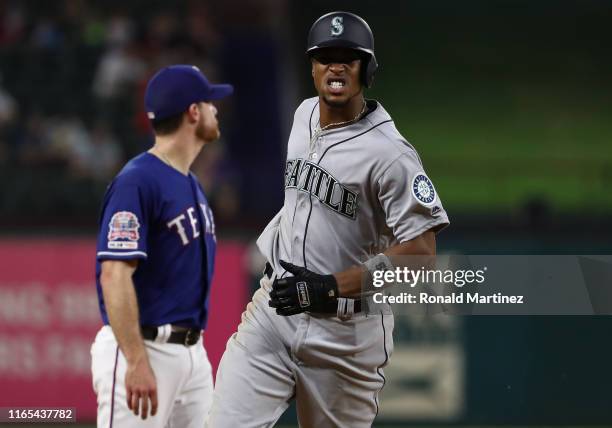 Keon Broxton of the Seattle Mariners runs the bases after hitting a two-run homerun against the Texas Rangers in the eighth inning at Globe Life Park...