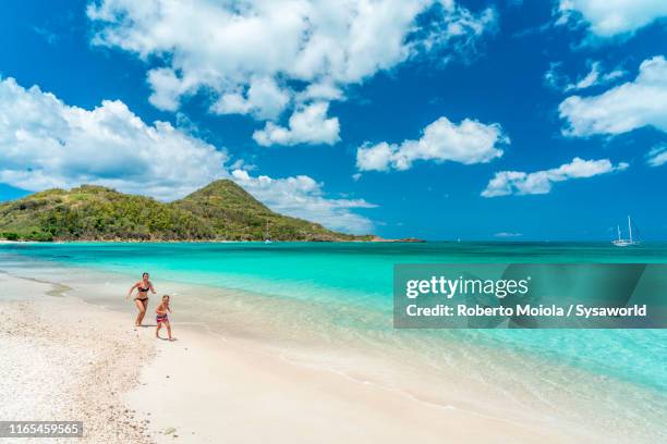 mother and son running on beach, caribbean - dominikanische republik stock-fotos und bilder