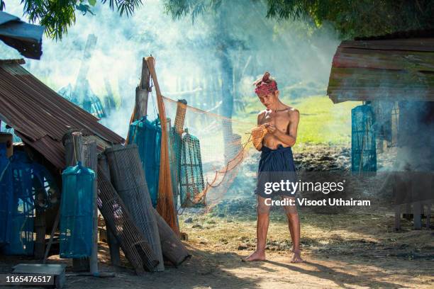 old fishermen are repairing fishing nets - national service stock pictures, royalty-free photos & images