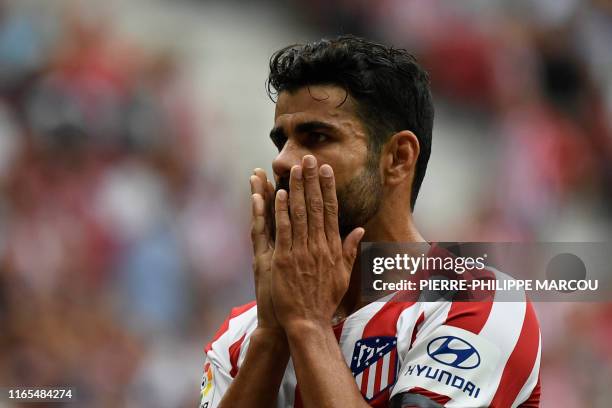 Atletico Madrid's Spanish forward Diego Costa reacts after missing a goal opportunity during the Spanish league football match Club Atletico de...