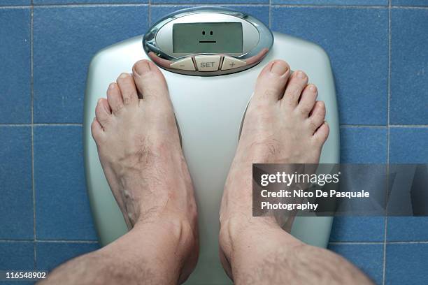 Person Standing On A Weight Scale Weighing Themselves Stock