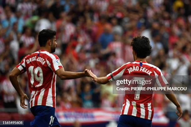 Atletico Madrid's Portuguese midfielder Joao Felix celebrates with Atletico Madrid's Spanish forward Diego Costa after scoring during the Spanish...