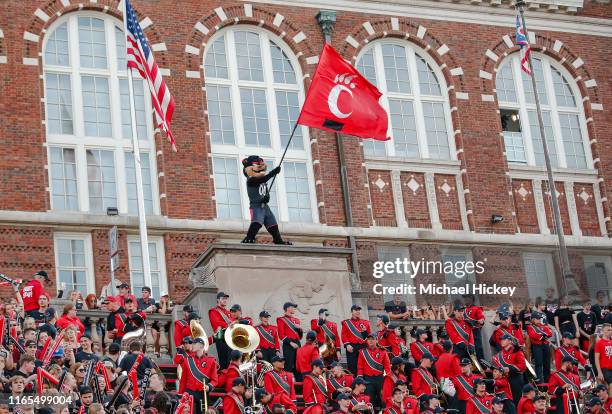 The Cincinnati Bearcats mascot waves a Cincinnati Bearcats flag during the game against the UCLA Bruins at Nippert Stadium on August 29, 2019 in...