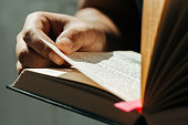 Close up of young man hands hold and reading holy bible.Christian faith concept