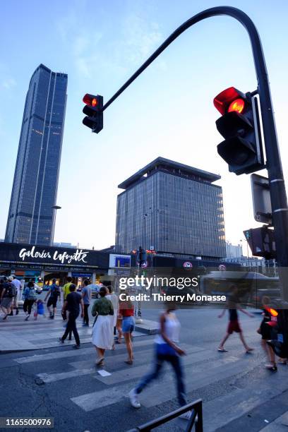 The Tour Montparnasse and Traffic light at dusk on August 28, 2019 in Paris, France. The Tour Maine-Montparnasse was constructed from 1969 to 1973,...