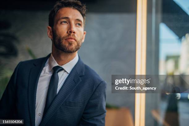 handsome gentleman in suit in cafe - modern manhood stock pictures, royalty-free photos & images