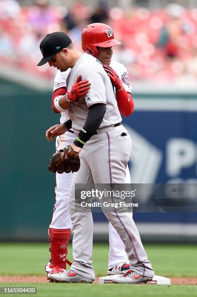 Juan Soto of the Washington Nationals hugs Martin Prado of the Miami Marlins after hitting a double in the second inning at Nationals Park on...