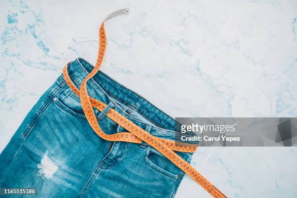 jeans denim and measure tape.top view - adipose cell stock pictures, royalty-free photos & images
