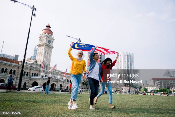 young adult celebrating malaysia independence day - malaysia kuala lumpur merdeka square stock pictures, royalty-free photos & images