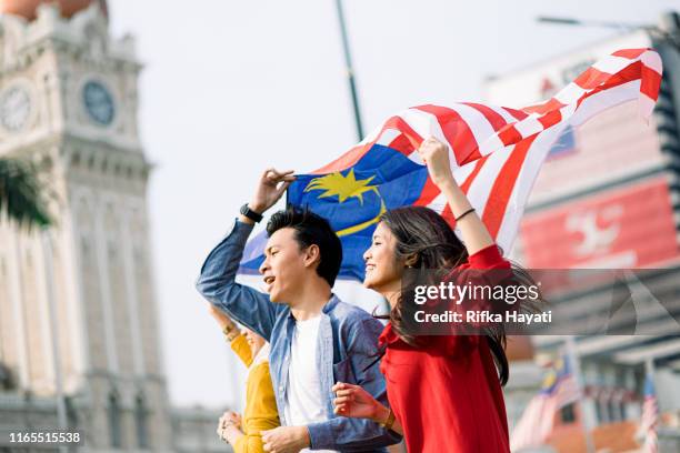 young adult celebrating malaysia independence day - malaysia kuala lumpur merdeka square stock pictures, royalty-free photos & images