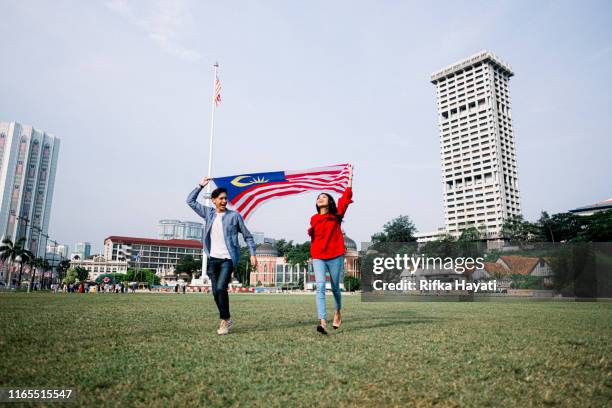 young adult celebrating malaysia independence day - dataran merdeka stock pictures, royalty-free photos & images