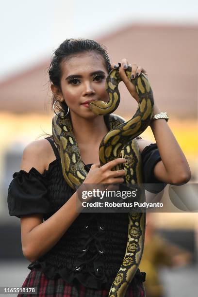 Model performs with a snake during Pets Carnival as part of the 18th Jember Fashion Carnival 2019 on August 01, 2019 in Jember, Indonesia. The 18th...