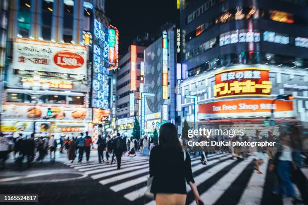 japanese women stand at the intersection of kabukicho in shinjuku - kabuki cho stock pictures, royalty-free photos & images