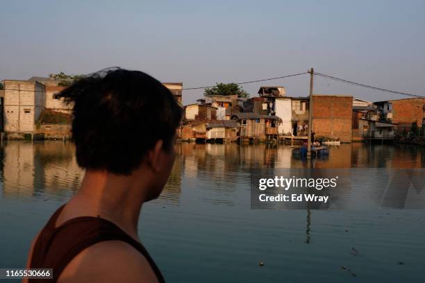 A man looks out over his kampung , Kapuk Teko which has gradually become surrounded by standing water. The Kampung which lies over 2.5 kilometres...