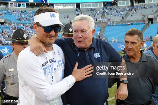 Country Music Singer Eric Church celebrates on the field with North Carolina Tar Heels head coach Mack Brown after the Belk College Kickoff game...