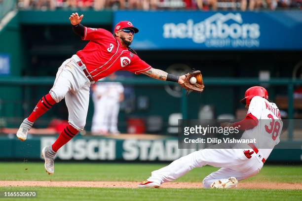 Jose Martinez of the St. Louis Cardinals steals second base against Freddy Galvis of the Cincinnati Reds in the seventh inning during game one of a...