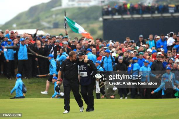 Shane Lowry of Ireland celebrates with caddie Bo Martin on the 18th hole during the final round of the 148th Open Championship held on the Dunluce...