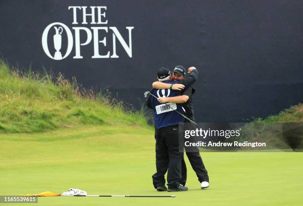 Shane Lowry of Ireland celebrates his victory with his caddie Brian Bo Martin on the 18th hole during the final round of the 148th Open Championship...