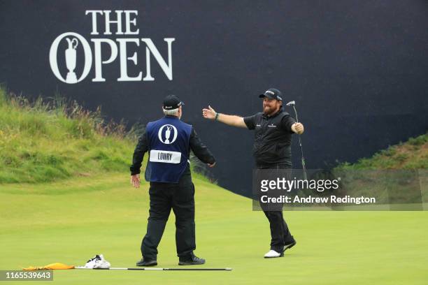 Shane Lowry of Ireland celebrates his victory with his caddie Brian Bo Martin on the 18th hole during the final round of the 148th Open Championship...