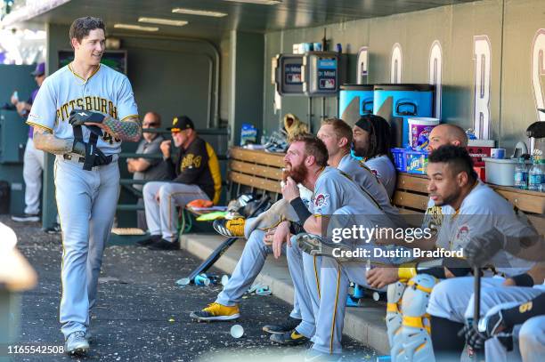 Steven Brault of the Pittsburgh Pirates smiles as he walks through the dugout ignored by teammates after hitting his first career home run against...