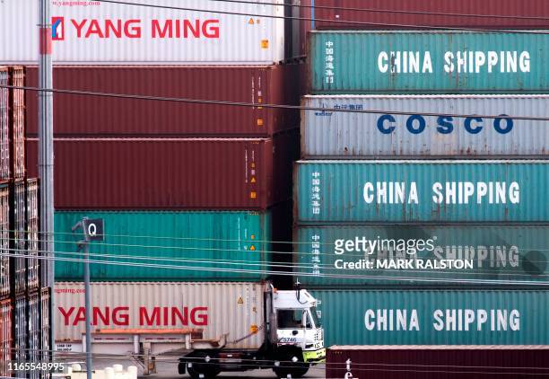 Truck passes by China Shipping containers at the Port of Los Angeles, after new tariffs on Chinese imports was imposed by President Trump, in Long...