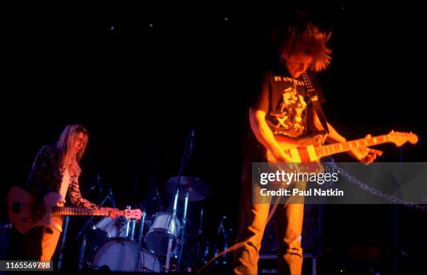 American Alternative Rock musicians Kim Gordon , on bass guitar, and Thurston Moore, on guitar, both of the group Sonic Youth, perform onstage at the...