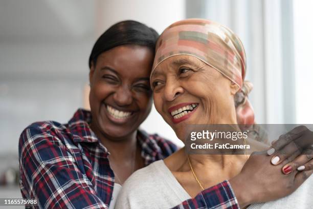 courageous woman with cancer spends precious time with adult daughter - black bandana stock pictures, royalty-free photos & images
