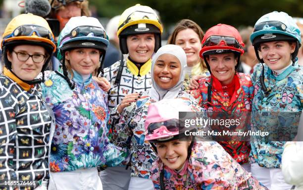 Khadijah Mellah celebrates with her fellow jockeys after winning the 'Magnolia Cup' charity ladies race on 'Ladies Day' of the Qatar Goodwood...