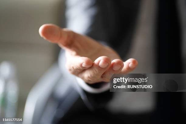 close up of businessman with open hand out - handfläche stock-fotos und bilder