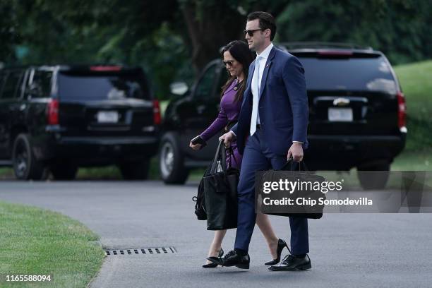 White House Press Secretary Stephanie Grisham and Deputy Assistant to the President for Operations Nicholas Luna walk across the South Lawn as they...