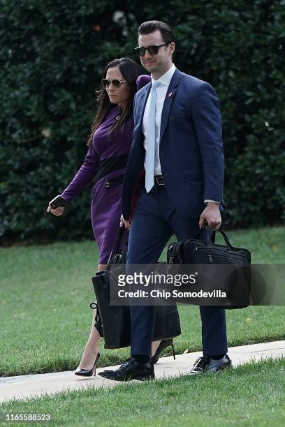 White House Press Secretary Stephanie Grisham and Deputy Assistant to the President for Operations Nicholas Luna walk across the South Lawn as they...