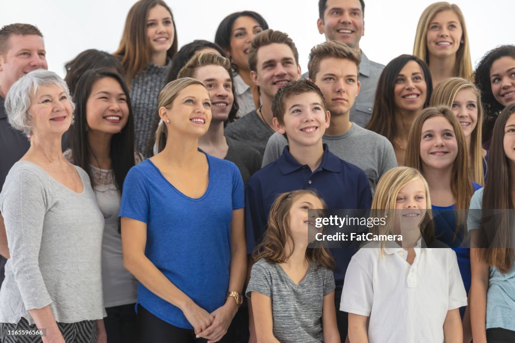 Large, diverse group of people gathered indoors