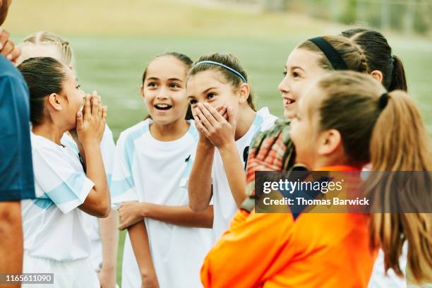 young female soccer players laughing together - soccer team coach stock pictures, royalty-free photos & images