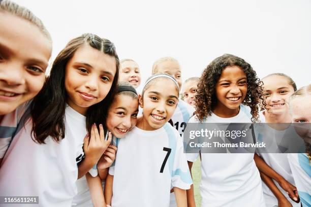 portrait of smiling young female soccer team - african american girl wearing a white shirt stock pictures, royalty-free photos & images