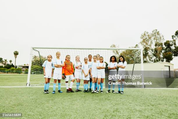 portrait of young female soccer team standing together in front of goal - local soccer field stock pictures, royalty-free photos & images