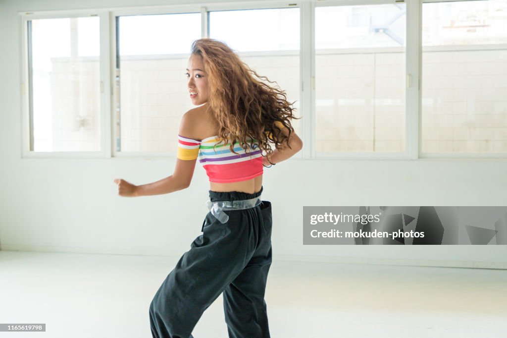 Young female dancers dance in studio