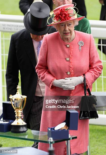 Queen Elizabeth II prepares to present the Gold Cup in the Parade Ring on Ladies Day at Royal Ascot at Ascot Racecourse on June 14, 2011 in Ascot,...