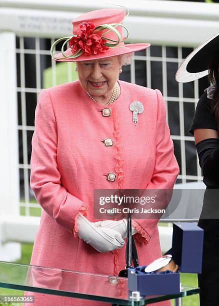 Queen Elizabeth II prepares to present the Gold Cup in the Parade Ring on Ladies Day at Royal Ascot at Ascot Racecourse on June 14, 2011 in Ascot,...