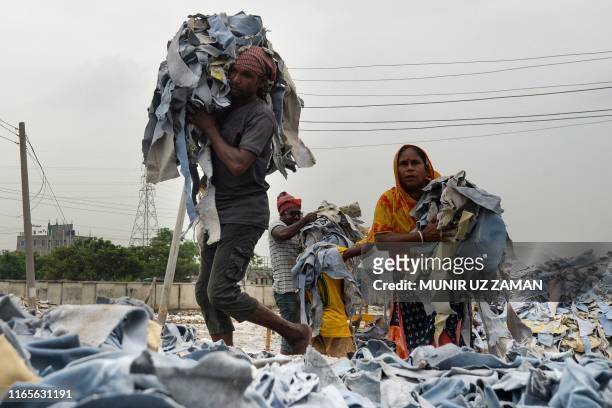 Bangladeshi labourers unload tannery waste at an export processing zone in Savar on September 2, 2019.
