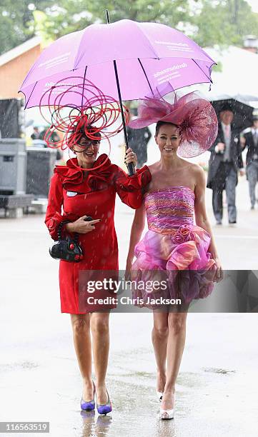 Racegoers arrive in the rain on Ladies Day at Royal Ascot at Ascot Racecourse on June 14, 2011 in Ascot, United Kingdom.