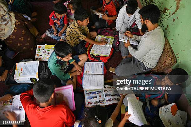 Kashmiri children study at a private home tuition centre during a lockdown on the outskirts of Srinagar on September 2, 2019.